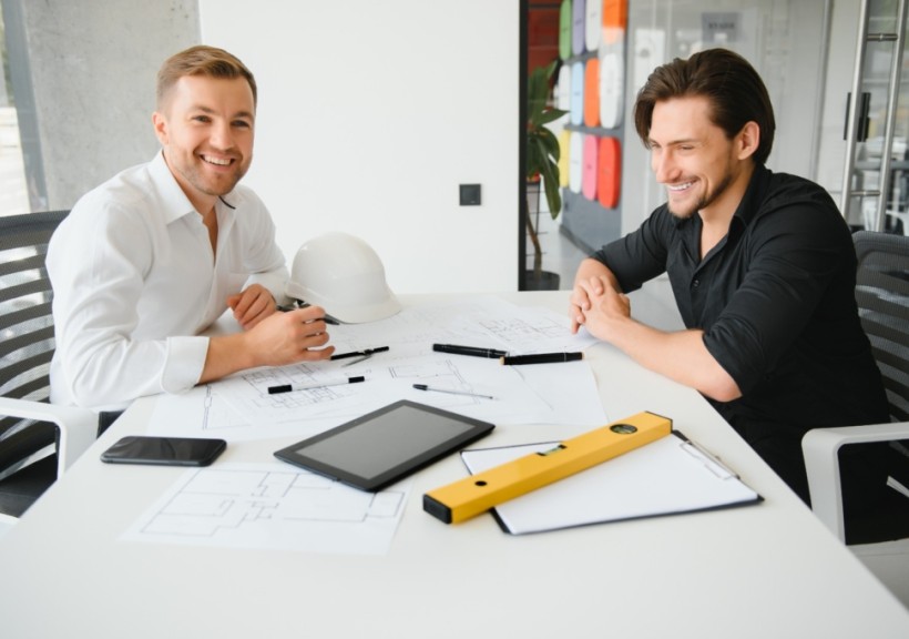 Engineers calculating and talking in a meeting